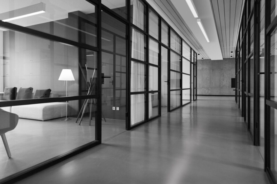 surface mounted linear led luminaires in a hallway with glass office walls